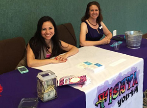 Chaperones Ana Alicia Perez and Emily Leeper welcome LGBT teens to the Fiesta Youth prom on May 7. (Photo courtesy Fiesta Youth)